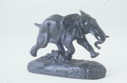 Bronze sculpture of a young elephant in mid stride