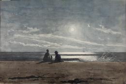 A couple resting on the sand looking out at the moon rising above the sea