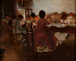 women sit along a long table. Upon the table they are making lace. The women's faces are mostly obscured. Their dresses are many colors. 