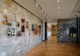 History exhibit with glass panels mounted on a stone wall